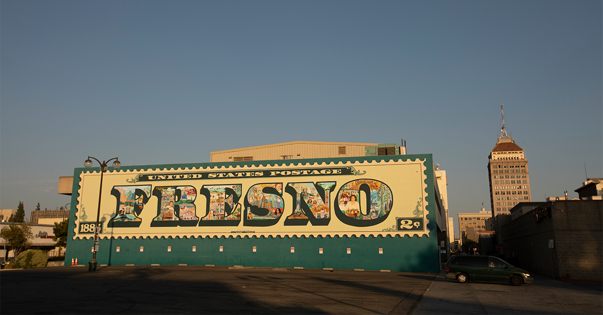 A mural of a vintage "Fresno" postage stamp painted on a building in Fresno, California.