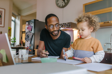A father and son drawing together.
