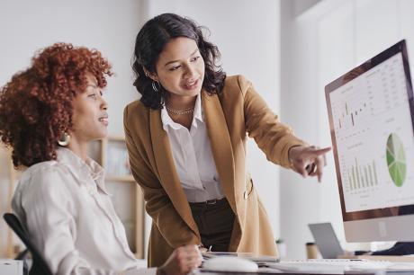 Employee women in teamwork collaboration looking at company data or analysis