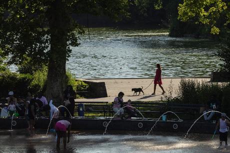 People run across a splash pad at LeFrak Center at Lakeside at Prospect Park in Brooklyn, New York
